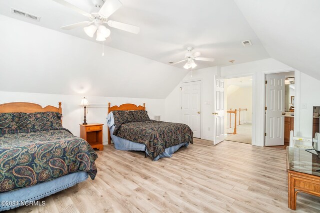 bedroom featuring ceiling fan, light wood-type flooring, and vaulted ceiling