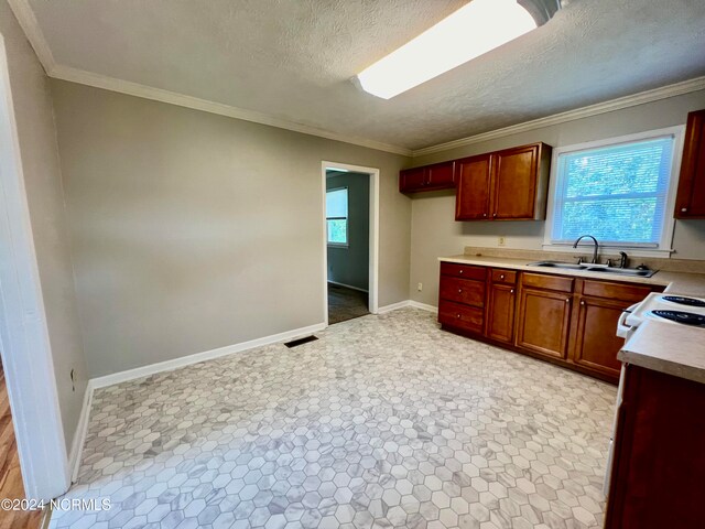 kitchen featuring a textured ceiling, sink, white appliances, and ornamental molding