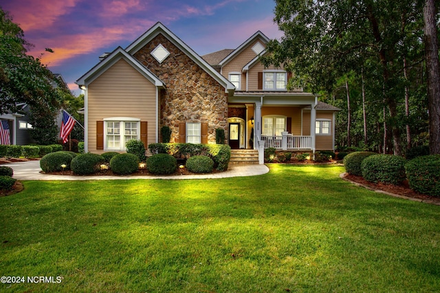 craftsman-style home featuring a lawn and a porch