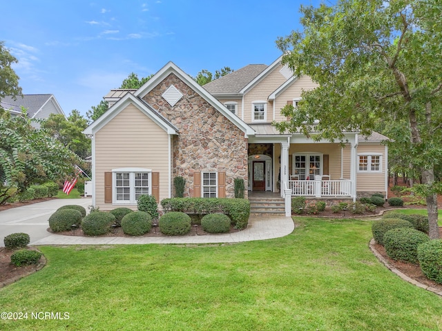 view of front of home featuring a front yard and a porch