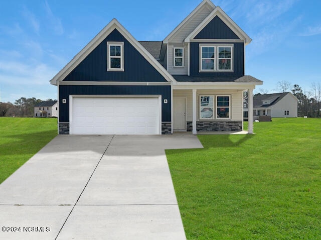 craftsman inspired home featuring a front lawn and a garage