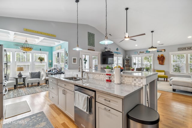 kitchen featuring dishwasher, french doors, sink, light stone countertops, and white cabinetry