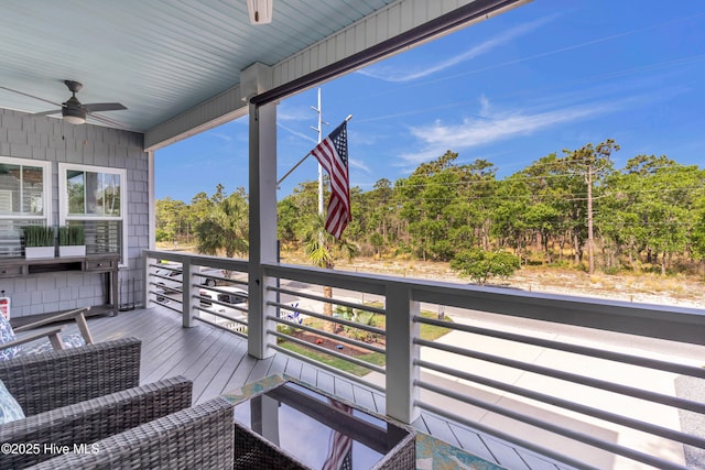 910 Old Dow Rd, Carolina Beach, NC 28428 - wooden deck featuring ceiling fan and view of wooded area