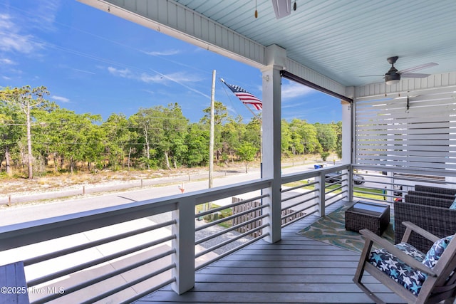 910 Old Dow Rd, Carolina Beach, NC 28428 - wooden terrace with ceiling fan and view of wooded area