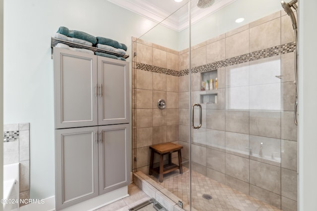 bathroom with tile patterned flooring, ornamental molding, and a shower with shower door