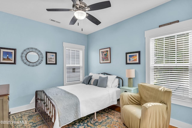 910 Old Dow Rd, Carolina Beach, NC 28428 - bedroom with baseboards, wood finished floors, and a ceiling fan