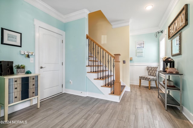 foyer featuring light hardwood / wood-style floors and crown molding