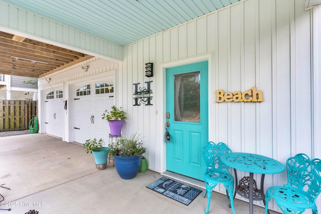 910 Old Dow Rd, Carolina Beach, NC 28428 - view of exterior entry featuring a garage, board and batten siding, and driveway