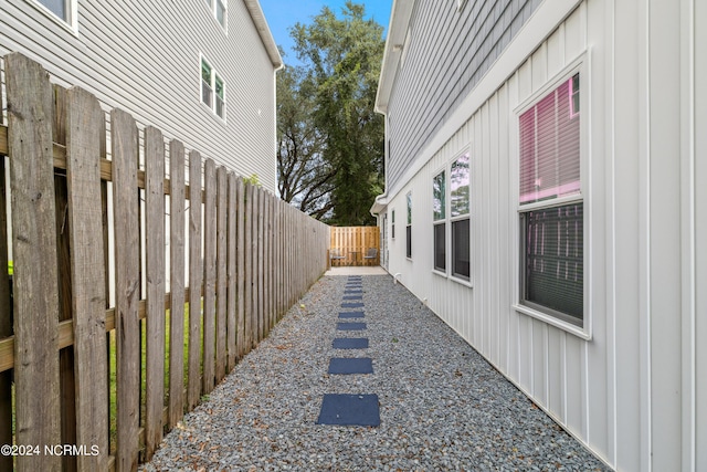 910 Old Dow Rd, Carolina Beach, NC 28428 - view of side of home with board and batten siding and a fenced backyard
