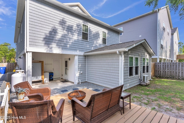 910 Old Dow Rd, Carolina Beach, NC 28428 - back of house featuring an outdoor fire pit, a fenced backyard, and a wooden deck