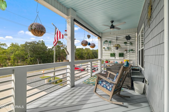 deck with ceiling fan and covered porch