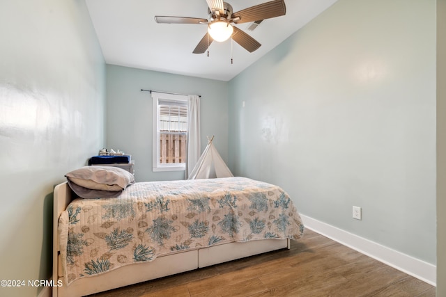 910 Old Dow Rd, Carolina Beach, NC 28428 - bedroom with wood finished floors, baseboards, a ceiling fan, and vaulted ceiling