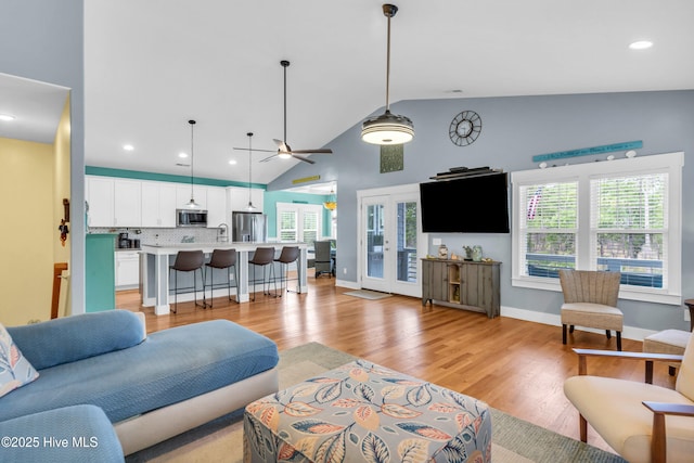 910 Old Dow Rd, Carolina Beach, NC 28428 - living area featuring light wood finished floors, healthy amount of natural light, recessed lighting, a ceiling fan, and high vaulted ceiling