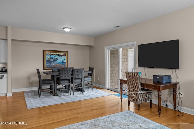 dining area with light hardwood / wood-style flooring