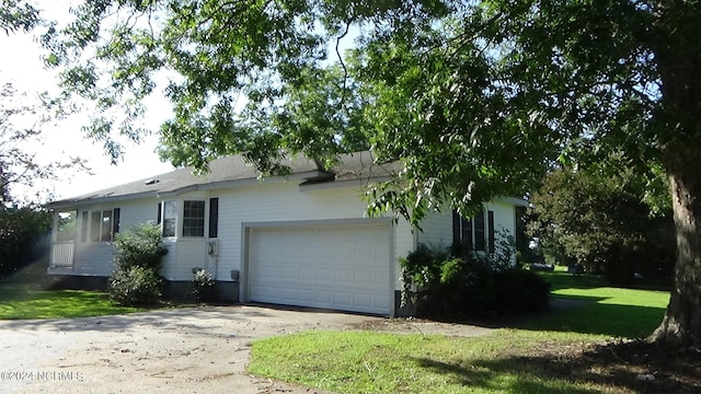 single story home featuring a garage and a front lawn