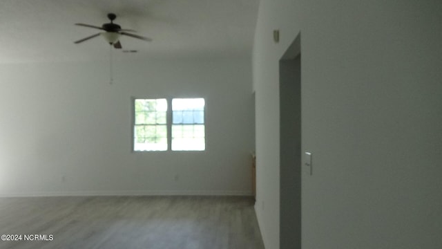 unfurnished room with ceiling fan and light hardwood / wood-style floors