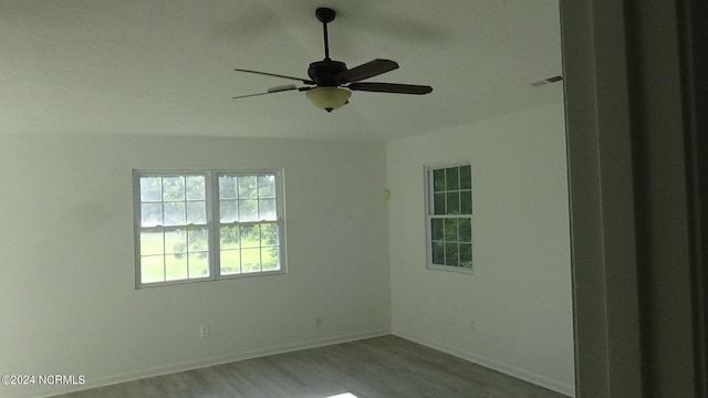 spare room with ceiling fan and wood-type flooring