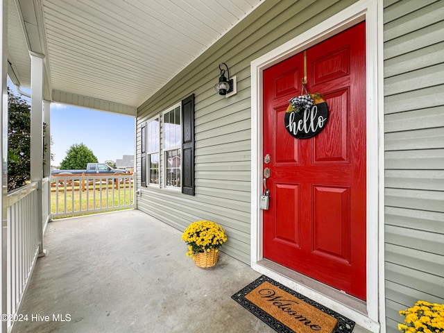 view of exterior entry with a porch