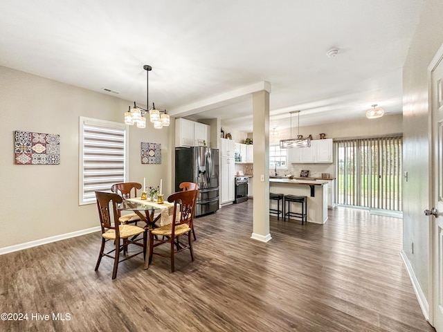 dining area with dark hardwood / wood-style flooring