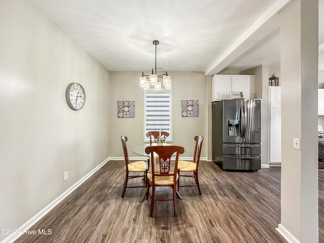 dining area with a notable chandelier and dark wood-type flooring