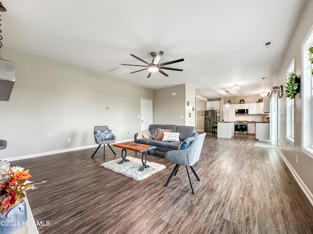 living room featuring ceiling fan and hardwood / wood-style floors