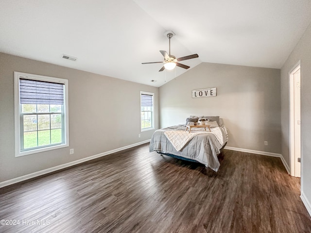 bedroom with ceiling fan, vaulted ceiling, and dark hardwood / wood-style floors