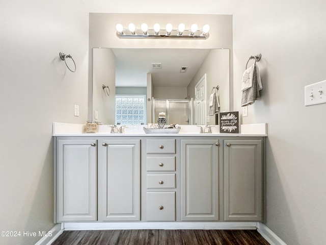 bathroom with a shower with door, wood-type flooring, and vanity