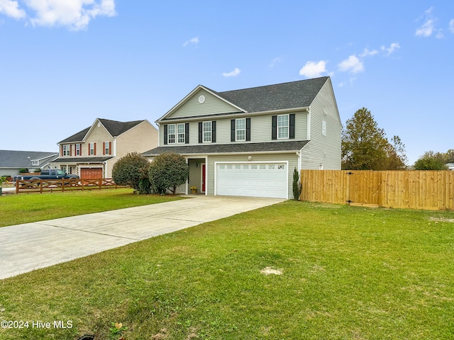 view of front of house with a front lawn and a garage