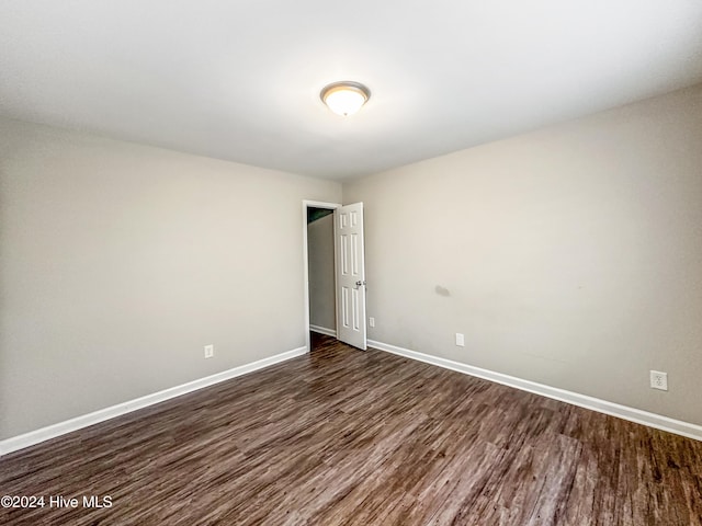 unfurnished room featuring dark hardwood / wood-style flooring