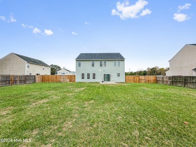 back of property featuring a yard