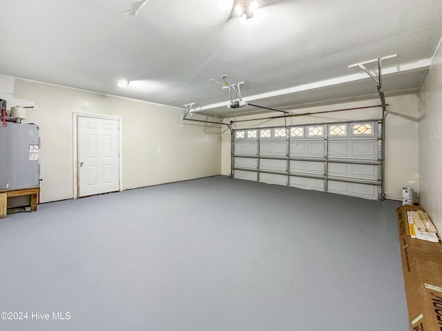 garage with a garage door opener and water heater