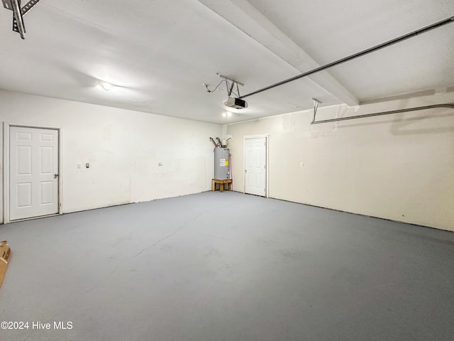 garage featuring water heater and a garage door opener