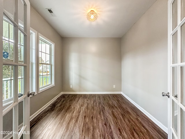 spare room with french doors and dark hardwood / wood-style floors