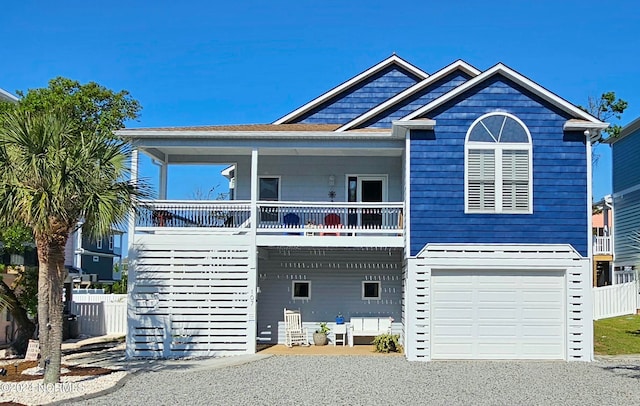 view of front facade featuring a porch and a garage