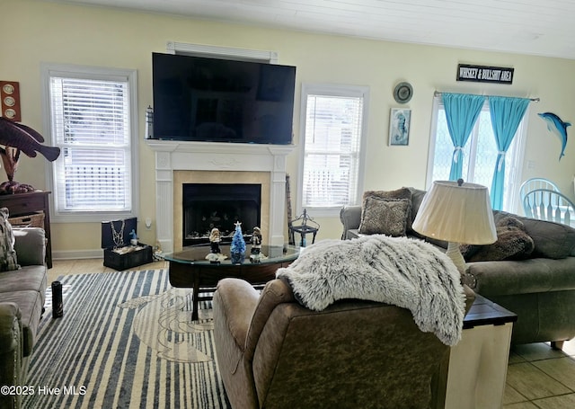 living room with tile patterned floors, plenty of natural light, and wooden ceiling