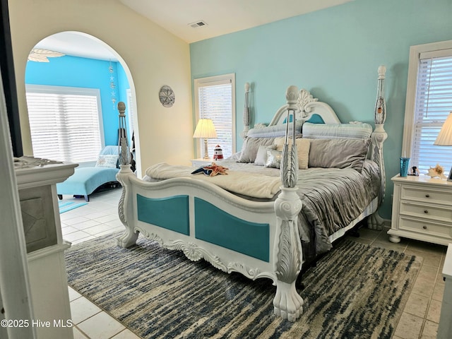 tiled bedroom featuring multiple windows