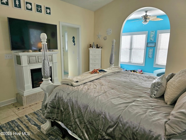 bedroom with ceiling fan and light tile patterned flooring