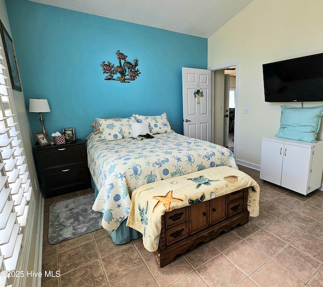 bedroom featuring tile patterned floors and lofted ceiling