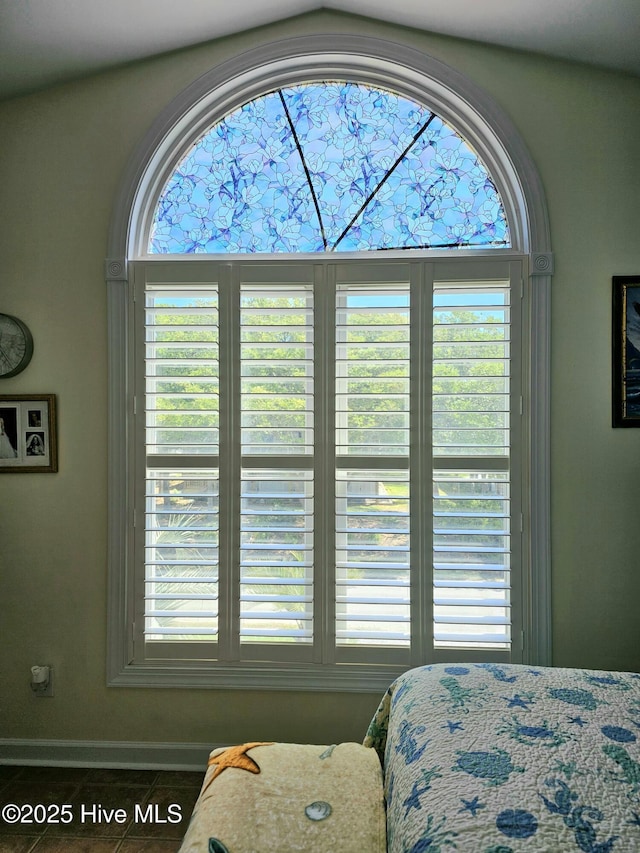 bedroom with multiple windows and tile patterned flooring