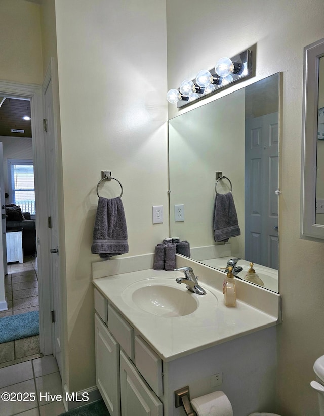 bathroom featuring toilet, tile patterned floors, and vanity