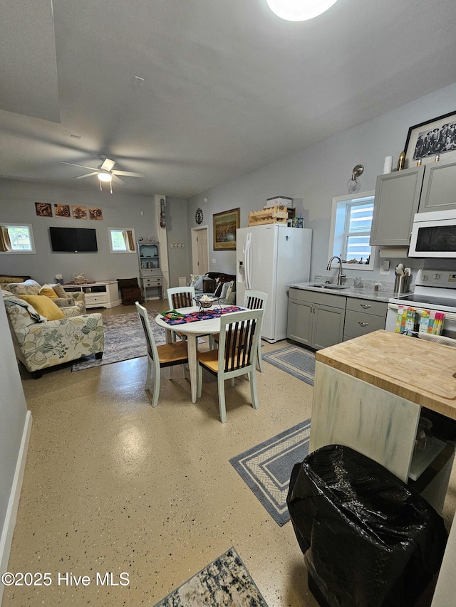 dining area featuring ceiling fan and sink