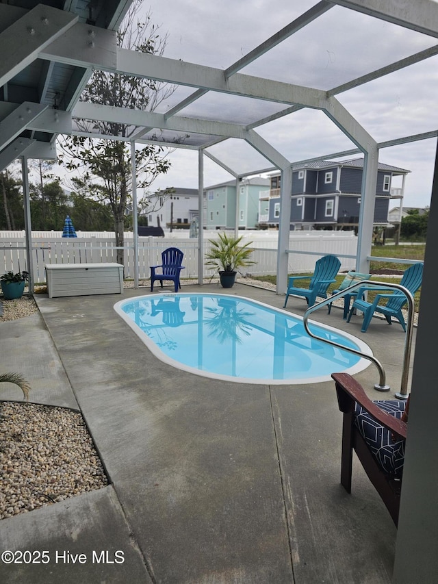 view of pool with a lanai and a patio