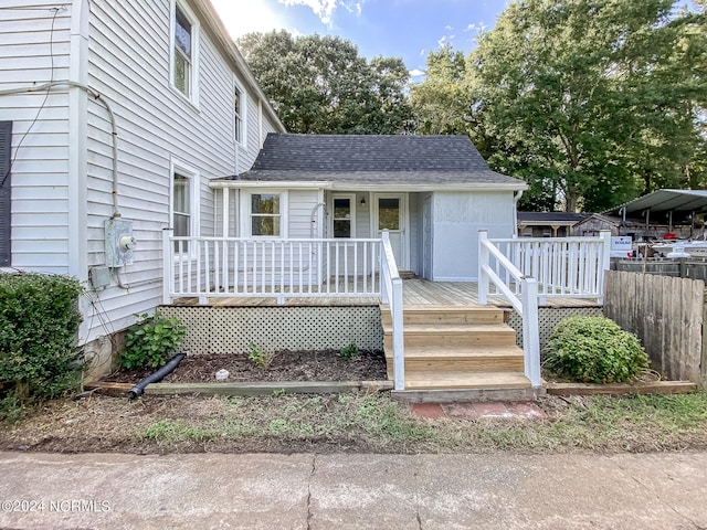 view of front of property with a wooden deck and a carport