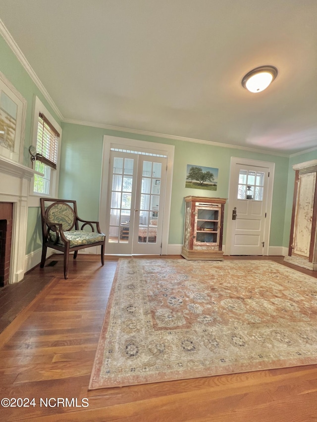 living room featuring crown molding, french doors, and hardwood / wood-style flooring