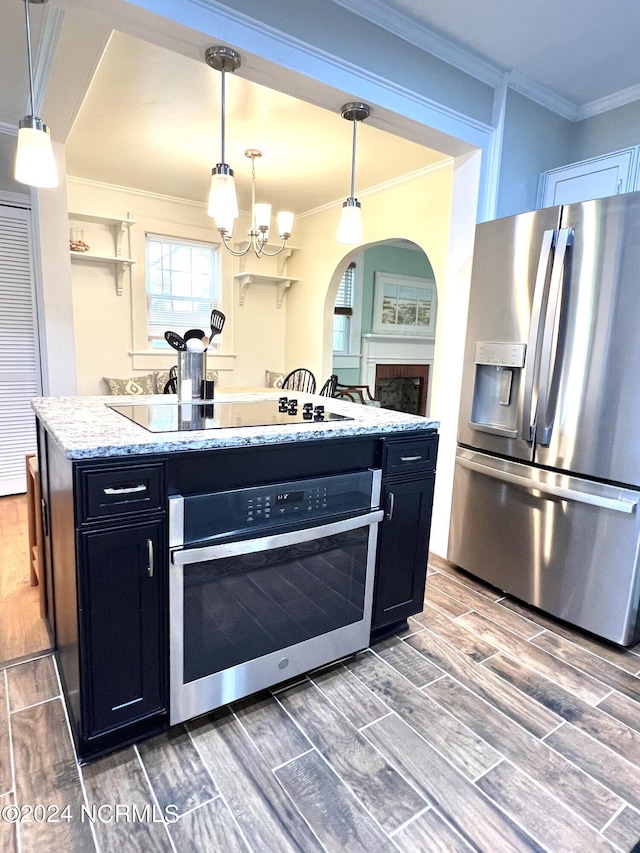 kitchen with pendant lighting, an inviting chandelier, stainless steel appliances, dark hardwood / wood-style flooring, and ornamental molding