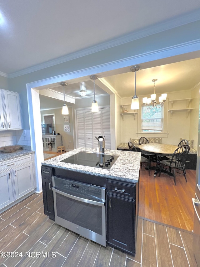 kitchen featuring tasteful backsplash, white cabinets, stainless steel oven, black electric stovetop, and dark hardwood / wood-style floors