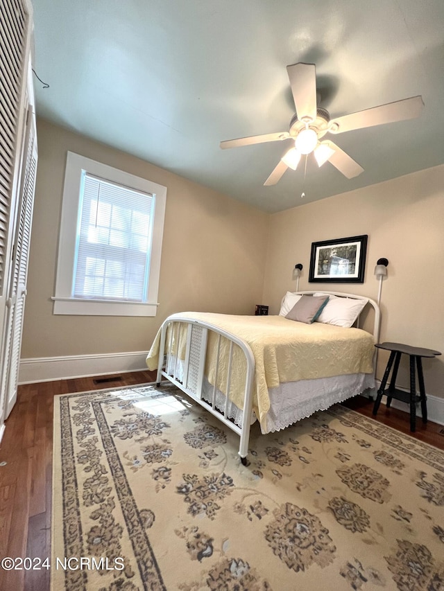 bedroom featuring ceiling fan and dark hardwood / wood-style flooring