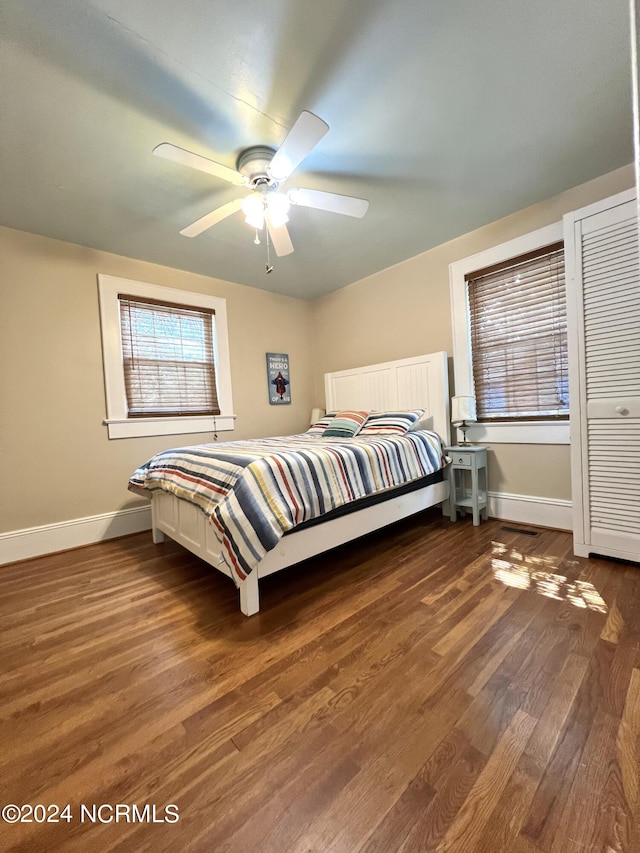 bedroom with ceiling fan and dark wood-type flooring