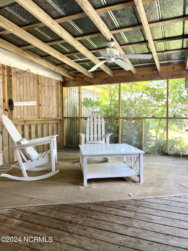 unfurnished sunroom with ceiling fan