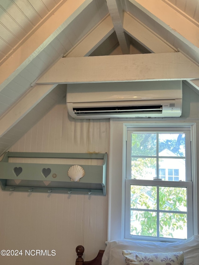 room details featuring beam ceiling, wood walls, and a wall mounted air conditioner